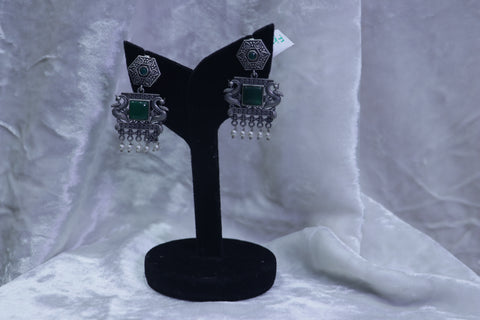 Fancy white metal with green ear rings