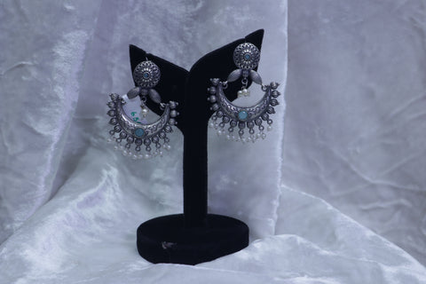 Fancy white metal half moon earrings