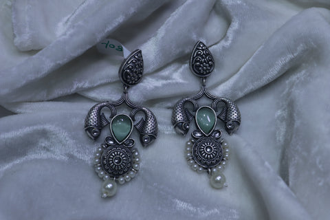 Fancy white metal fish with ice green stone earrings